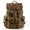 Front view of vintage waxed canvas hunting hydration backpack with leather flap and brass buckles