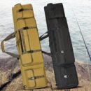 Khaki hunting day backpack standing upright on rocky shoreline with fishing rod inside